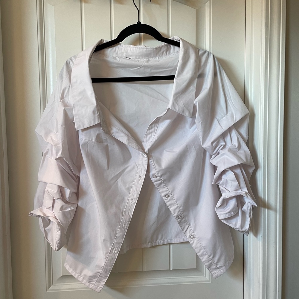 Off one or both shoulder top. Ruffle sleeve.